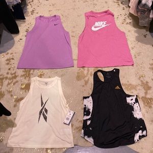 4 Womens workout tank tops.. never worn! Smoke free and pet free home